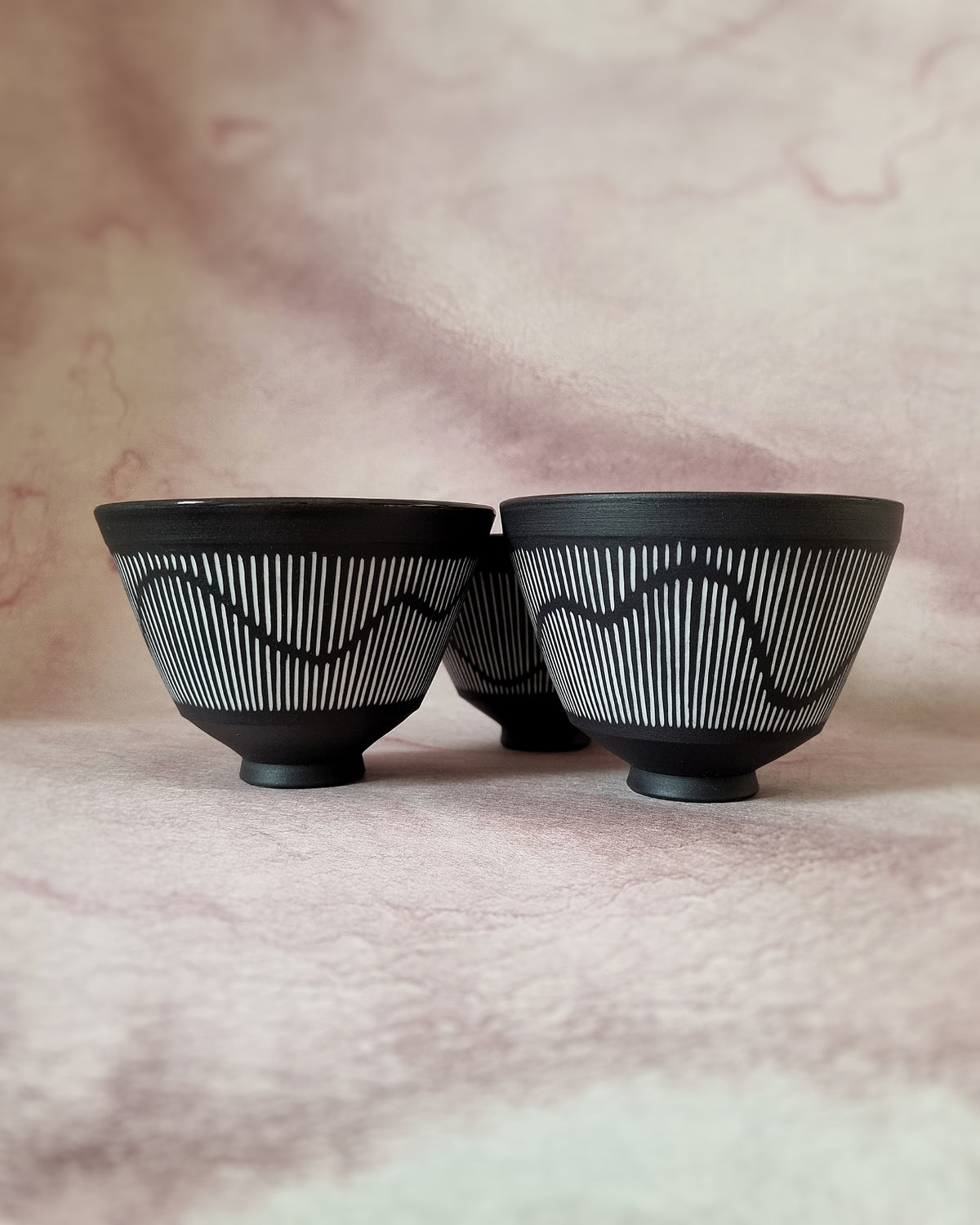 Small black porcelain bowl, white porcelain inlay, fluid pattern