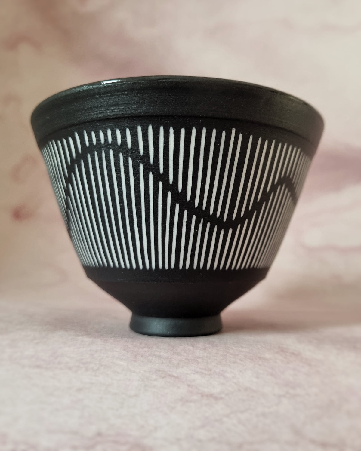 Small black porcelain bowl, white porcelain inlay, fluid pattern