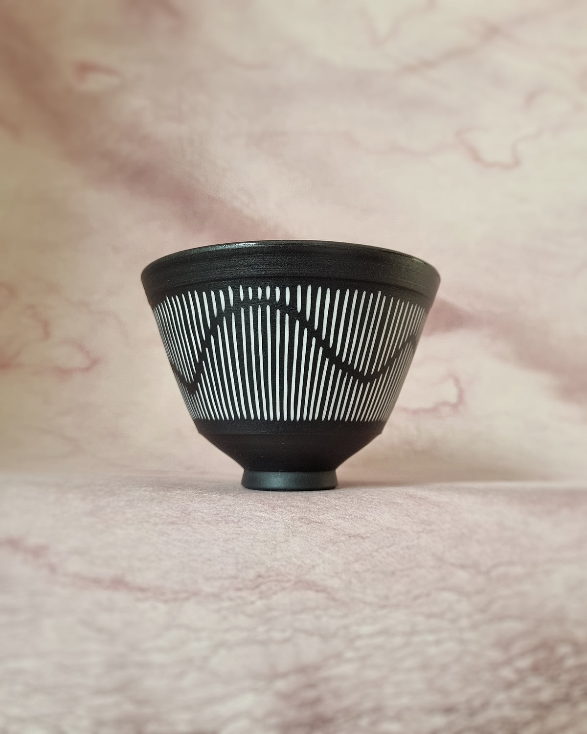 Small black porcelain bowl, white porcelain inlay, fluid pattern