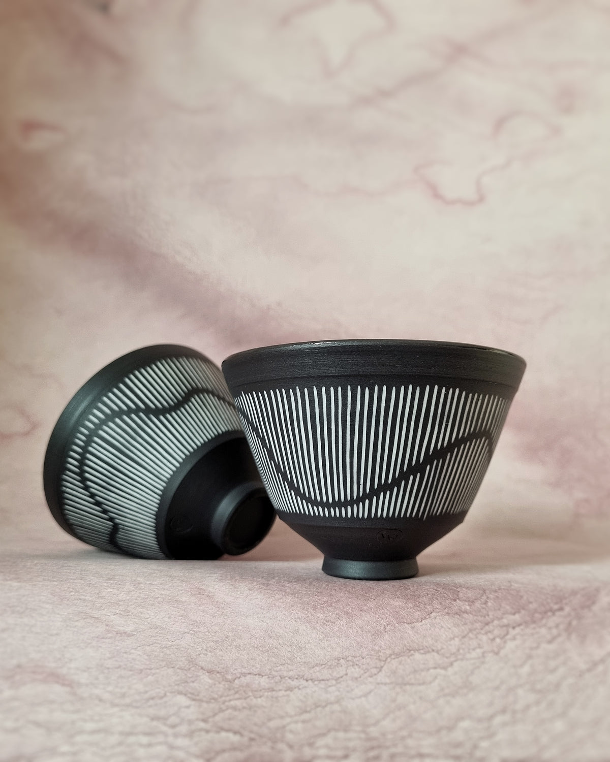 Small black porcelain bowl, white porcelain inlay, fluid pattern