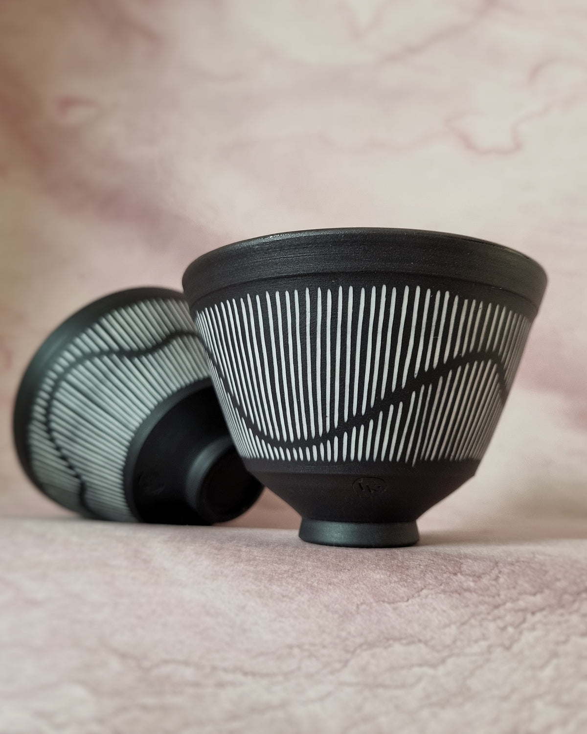 Small black porcelain bowl, white porcelain inlay, fluid pattern