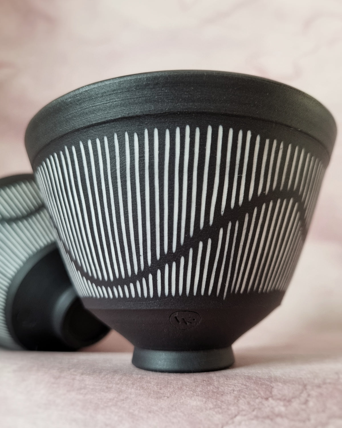 Small black porcelain bowl, white porcelain inlay, fluid pattern